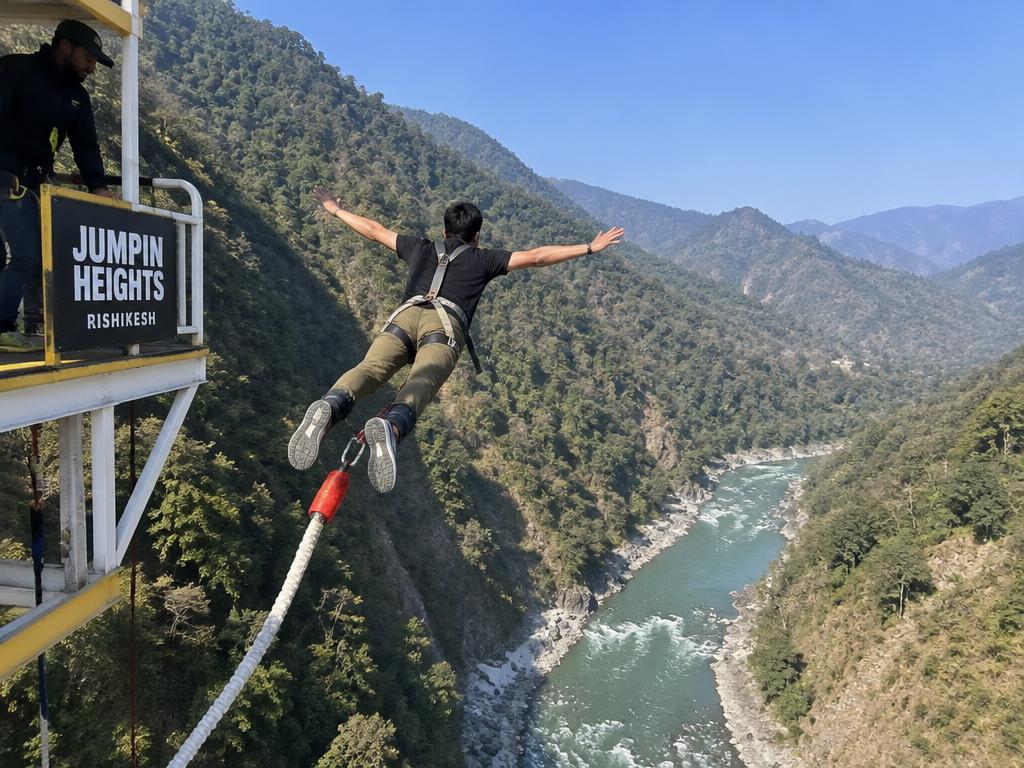 Bungee jumping over a river gorge in Rishikesh — jumper mid-air from the platform